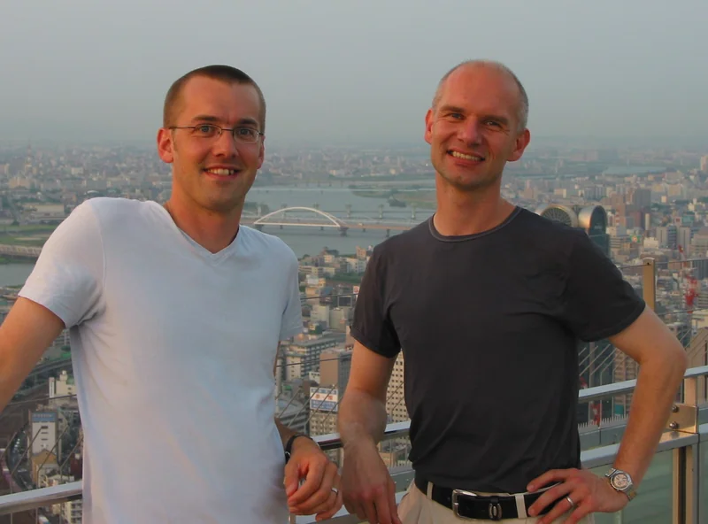 Hans Lamecker with a companion, overlooking a city.